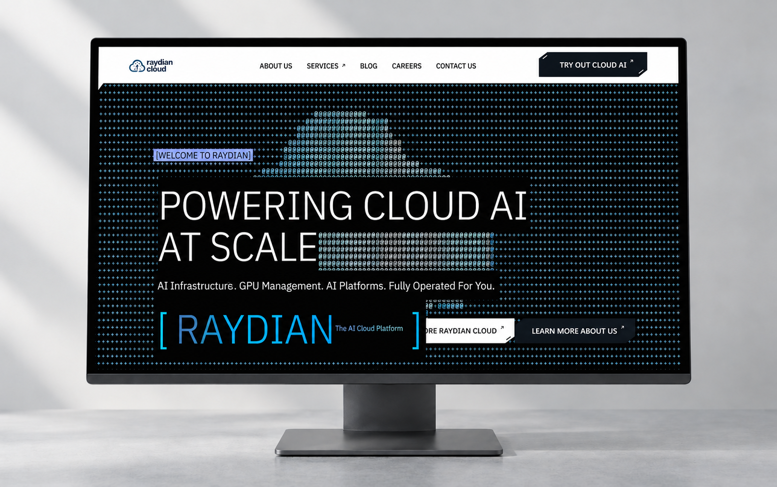 Raydian Cloud website displayed on a desktop monitor in a pale-grey studio.